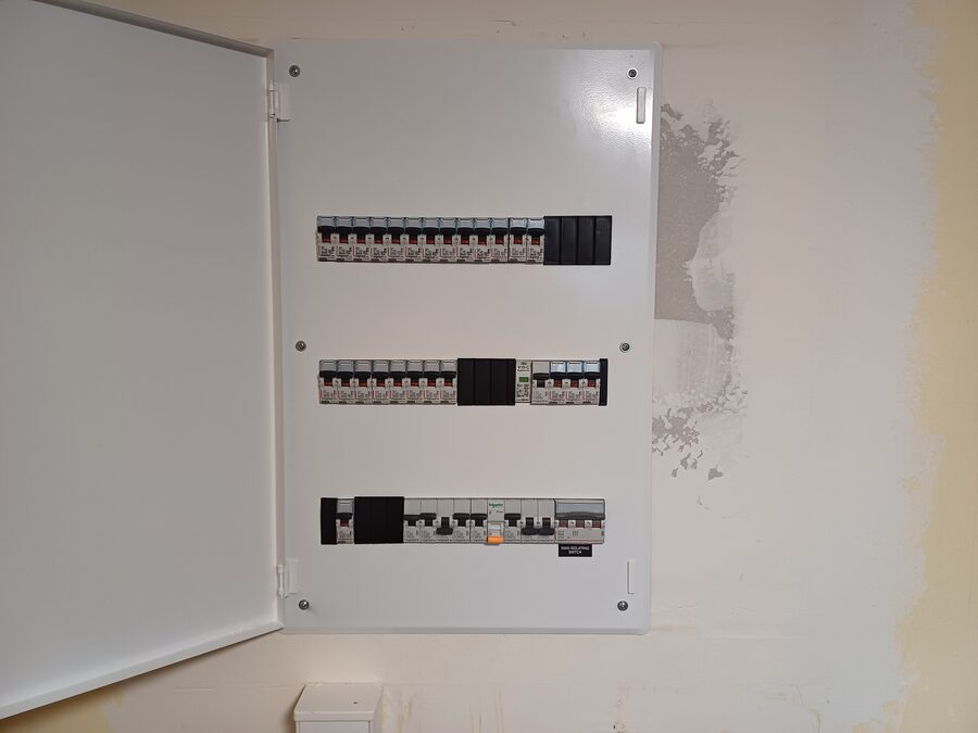 Electrician repairing a switchboard fault in Hamilton